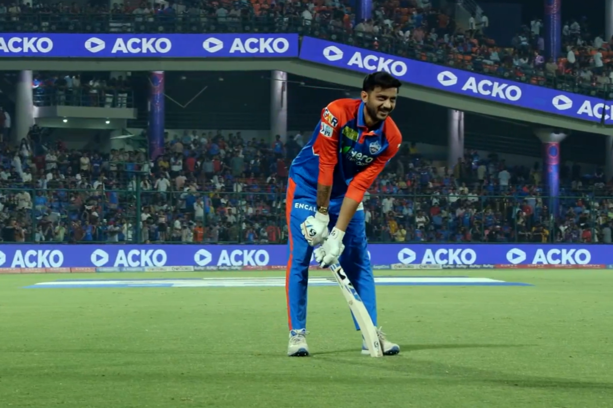 Axar Patel grimacing while trying to swing his bat after injuring his hand in the KKR innings during DC vs KKR IPL 2025 match